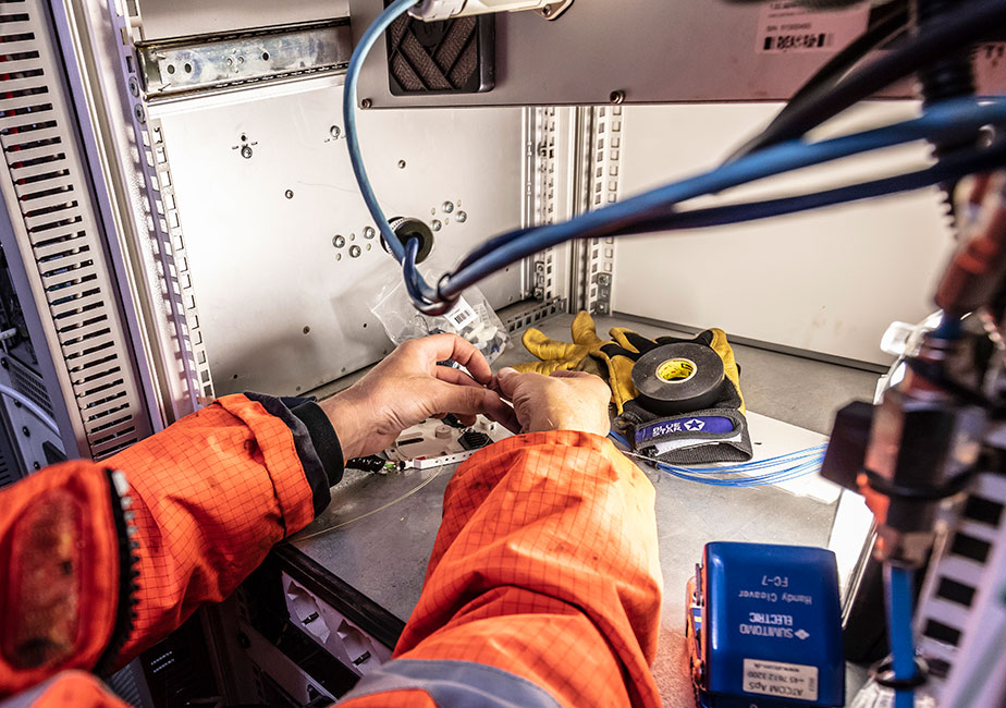 Engineer installing offshore surveillance equipment